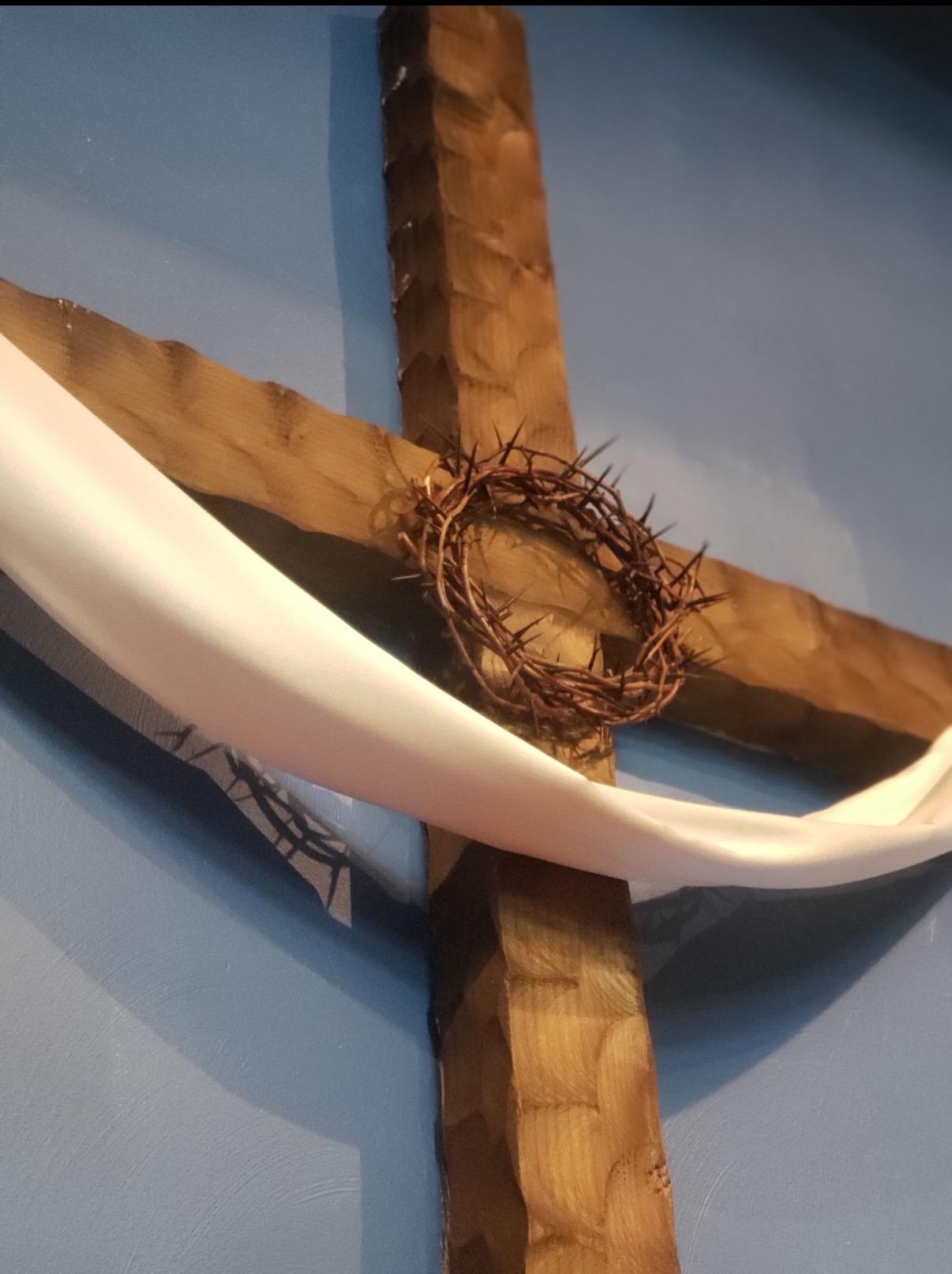Wooden cross with crown of thorns inside the church