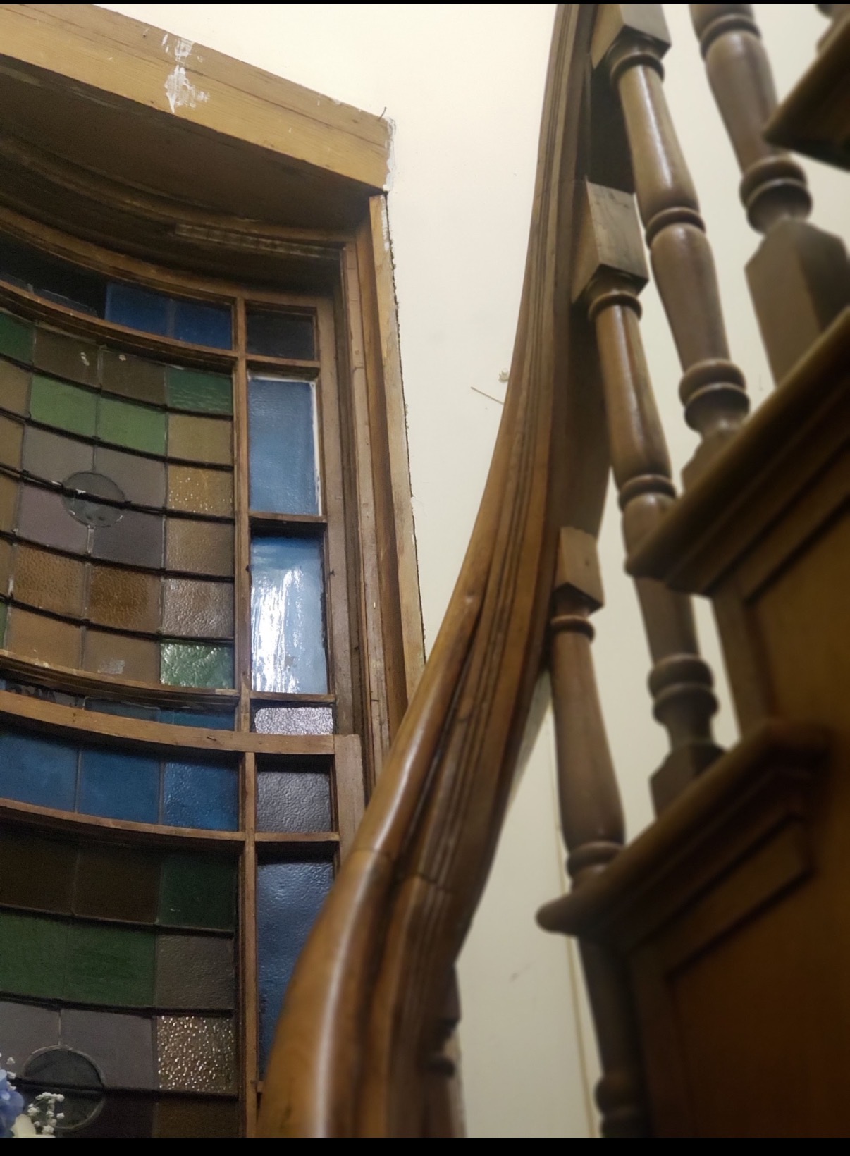 Stained glass window and wooden stair detail