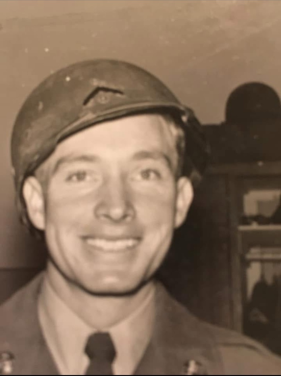 Russell East smiling in uniform and cap